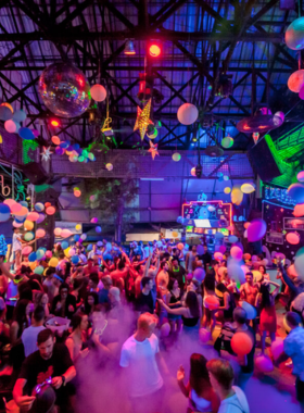 This image shows Soi Green Mango, the lively party street in Chaweng, Koh Samui, with colorful lights, buzzing bars, and an energetic crowd enjoying the vibrant nightlife.