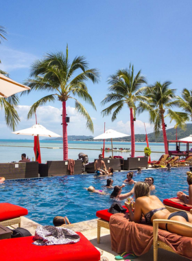 : This image shows Beach Republic Ocean Club in Lamai, Koh Samui, a sleek and luxurious venue with a poolside bar, international cuisine, and live DJ performances.