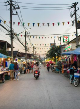 This image shows the vibrant Pai Night Market, bustling with activity as visitors explore colorful stalls selling handmade goods, street food, and local art. The lively atmosphere, with lanterns glowing in the dark, creates a warm, inviting scene. The market is popular among both locals and tourists, offering a chance to experience Pai’s unique blend of culture, food, and entertainment.