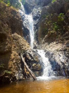 This image shows Mae Yen Waterfall, one of Pai’s most beautiful natural attractions. Visitors hike through lush trails to reach the waterfall, which cascades over rocks, creating a stunning display of water and natural beauty. The surrounding forest and the sound of rushing water make it a peaceful and invigorating spot for nature lovers and adventure seekers.