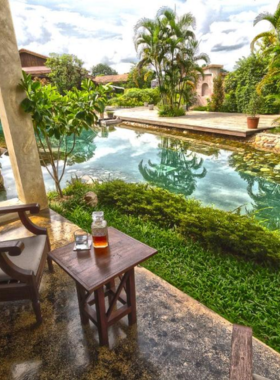 This image shows Reverie Siam Resort, an upscale resort featuring two outdoor pools, lush gardens, and beautifully designed rooms. The resort offers a peaceful atmosphere and top-tier service, ensuring a memorable stay in Pai. It is the perfect place for guests seeking luxury, relaxation, and scenic views in a serene environment.