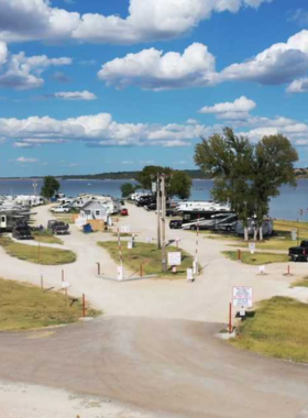 This image shows the tranquil Lake Waco, where visitors enjoy outdoor activities like fishing, boating, and picnicking by the water. The peaceful surroundings, with hiking trails and campgrounds, provide a relaxing escape for nature lovers.