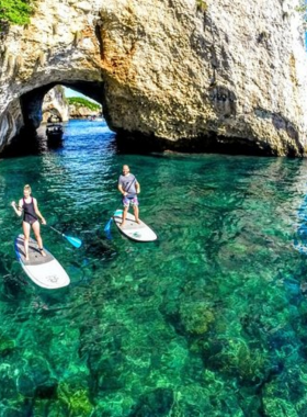  This image shows a snorkeler exploring the underwater world around Los Arcos Islands in Puerto Vallarta, with clear blue waters and colorful fish swimming among the vibrant coral reefs.