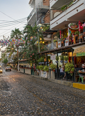 This image shows the cobblestone streets of the Zona Romántica in Puerto Vallarta, with charming cafes, art galleries, and the bustling vibe of this historic neighborhood, perfect for walking and discovering local culture.