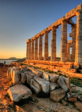 This image shows the Temple of Poseidon standing majestically at Cape Sounion. The ancient ruins are set against the backdrop of the Aegean Sea, with towering marble columns that have endured centuries of weathering. The scene is especially breathtaking during sunset, offering a serene and historical experience.