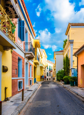 This image shows the charming Plaka neighbourhood, one of the oldest in Athens. Nestled at the foot of the Acropolis, Plaka is known for its narrow streets, picturesque buildings, and ancient ruins. The area also features cozy cafes and traditional Greek restaurants, offering a delightful historical atmosphere.