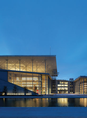 This image shows the Stavros Niarchos Foundation Cultural Centre in Athens, a modern cultural hub. It includes a park, a man-made river, and modern architecture, offering visitors the opportunity to enjoy cultural events and explore the National Opera and National Library of Greece in a beautiful outdoor setting.