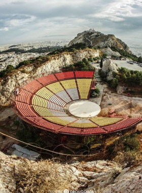 This image shows Lycabettus Hill in Athens, the highest point in the city, offering panoramic views of Athens. From here, you can see the Acropolis and the Mediterranean Sea. The summit features a whitewashed church, a café, and even a gourmet restaurant with stunning views.