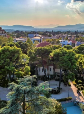 This image shows the Kifisia district in northern Athens, a peaceful and upscale area known for its elegant streets, high-end boutiques, cafes, and art galleries. It offers a serene atmosphere with beautiful parks, perfect for those seeking a more relaxed and luxurious side of Athens.