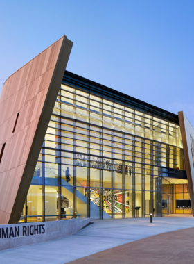 This image shows the National Center for Civil and Human Rights, featuring its modern architecture and visitors walking into the building. It symbolizes the center’s role in promoting dialogue on civil rights and global human rights issues.
