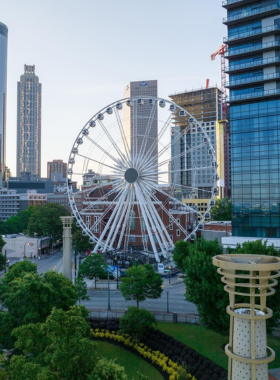 This image shows the SkyView Atlanta Ferris wheel, brightly lit against the evening sky. The enclosed gondolas offer panoramic views of the city skyline, creating a memorable attraction for visitors.