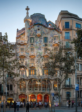 This image shows the colorful, dragon-inspired façade of Casa Batlló, designed by Antoni Gaudí. The unique, organic shapes and vibrant tiles make it one of the most iconic buildings in Barcelona, a true example of modernist architecture.