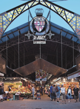 This image shows the colorful and vibrant stalls of Mercat de la Boqueria, Barcelona's famous food market. It captures the fresh produce, seafood, and local delicacies that attract food lovers from around the world.