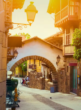 This image shows the charming cobblestone streets of Poble Espanyol, an open-air museum in Barcelona. The site replicates traditional Spanish villages, showcasing diverse architecture, arts, and crafts from across the country.