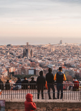 This image shows the breathtaking view from Bunkers del Carmel in Barcelona at sunset. The historical site, originally built as anti-aircraft bunkers during the Spanish Civil War, offers some of the best panoramic views of the city.