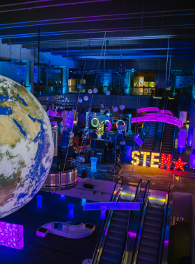 This image shows the Museum of Science in Boston, with its striking riverside location and a dinosaur sculpture outside the entrance. Inside, visitors can explore interactive exhibits, a planetarium, and live presentations that make science fun and accessible for all ages.