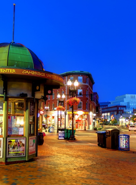 This image shows Harvard Square in Cambridge, bustling with students, tourists, and street performers. The vibrant area features historic architecture, unique shops, and cozy cafes, capturing the lively blend of culture, education, and entertainment in this iconic spot.