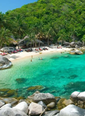 This image shows the breathtaking beauty of Koh Nang Yuan, a small island off Koh Tao, known for its white sandbars connecting three islands. The clear turquoise waters are perfect for snorkeling, while the lush green surroundings and stunning viewpoints offer a serene escape for nature lovers and adventure seekers alike.

