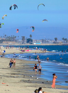 This image shows Yong Ling Beach, with its warm, inviting waters and a striking view of nearby mountains. Families and solo travelers can be seen swimming and strolling along the beach, relishing the peaceful ambiance.