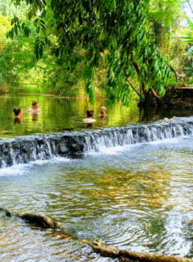 This image shows Pai’s natural hot springs, surrounded by dense foliage and a serene atmosphere. Visitors are seen relaxing in the warm waters, enjoying the tranquil ambiance and rejuvenating experience.