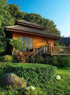 This image shows Pai Treehouse in Thailand, a charming and elevated wooden structure surrounded by trees, offering unique accommodations and scenic views.