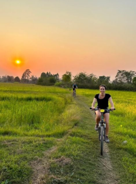 This image shows a cyclist pedaling through Sukhothai’s picturesque countryside, passing vibrant rice paddies and traditional Thai villages. The peaceful ride offers a unique opportunity to experience rural life, greeted by friendly locals and surrounded by the region's natural beauty.