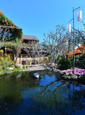 This image shows The Legend Chiang Rai Boutique River Resort and Spa, featuring a serene riverside setting, infinity pool, and lush greenery. The image reflects the resort’s peaceful ambiance and focus on relaxation.