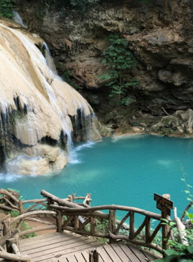5. Pha Tak Luang Waterfall This image shows the cascading waters of Pha Tak Luang Waterfall in the dense Chiang Rai jungle. The serene and dramatic scene is surrounded by vibrant greenery, making it an ideal location for nature and landscape photographers seeking tranquility.
