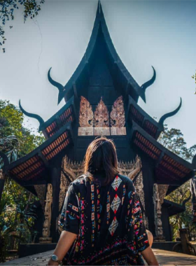 6. Baan Dam Museum (Black House) This image shows the unique dark-themed architecture of Baan Dam Museum in Chiang Rai. The intricately designed buildings are surrounded by gardens, offering a perfect combination of cultural and architectural beauty for photography enthusiasts.