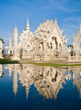 12. Wat Rong Khun (White Temple) This image shows the stunning white architecture of Wat Rong Khun in Chiang Rai. The intricate details, symbolic artwork, and surreal design create a magical and otherworldly scene perfect for artistic and architectural photography.