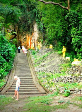 13. Tham Luang Cave This image shows the dramatic entrance of Tham Luang Cave, surrounded by dense greenery. Known for its historical significance, the cave offers unique rock formations and adventure photography opportunities in a serene natural setting.
