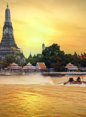 This image shows a serene boat tour along the Chao Phraya River in Ayutthaya, with tourists enjoying stunning views of ancient temples, lush greenery, and historical sites along the riverbanks. The boat gently floats on the calm waters, offering a peaceful and scenic experience. The golden hues of the sunset reflect on the water, adding a magical touch to the surroundings, making it a perfect adventure for nature lovers and history enthusiasts alike.