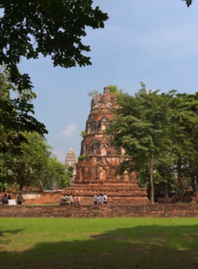 This image shows the peaceful Khlong Sa Bua Canal Trail in Ayutthaya, where visitors take a tranquil walk along the calm canal surrounded by lush greenery. The trail is lined with local wildlife and scenic views, creating a relaxing and nature-filled experience. Local vendors offer snacks along the way, adding to the charm of the quiet, serene environment. It’s an ideal spot for those looking to escape the hustle and bustle and enjoy Ayutthaya’s natural beauty.