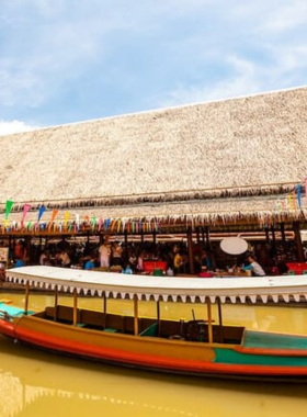 This image shows an exciting Tuk Tuk ride through Ayutthaya’s narrow streets, leading to the vibrant Floating Market. The ride is thrilling, offering a unique view of the local town as tourists travel through the busy streets. At the market, visitors can experience local food vendors, handmade goods, and a lively atmosphere. The Tuk Tuk ride adds to the adventure, giving tourists a taste of Ayutthaya’s culture while traveling in this traditional, colorful vehicle.