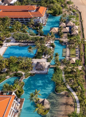 11. Conrad Bali This image shows Conrad Bali, a luxury beachfront resort offering breathtaking ocean views and world-class amenities. The resort features spacious rooms, an infinity pool, a spa, and a variety of dining options. Guests can enjoy water sports, explore the beautiful beach, and relax in the tranquil atmosphere, making it a perfect destination for those looking to indulge in luxury by the sea.