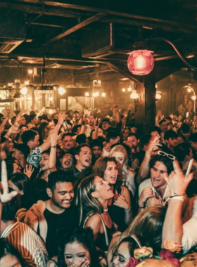 This image shows the energetic and vibrant scene at The Late Bali, one of the most exciting nightclubs in the area. The image captures the high-energy crowd, lively beats, and electrifying atmosphere where people dance to house and electronic music.