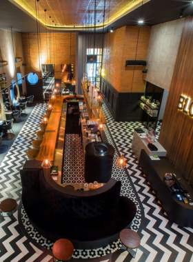 This image shows the funky, casual vibe at Blow Bar Bali, a lively spot known for creative cocktails and bold flavors. The image highlights the fun, laid-back crowd enjoying drinks and music in an alternative, relaxed atmosphere compared to larger nightclubs.