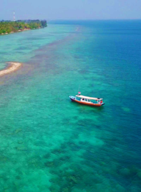 This image shows the peaceful beaches of Tidung Island, located in the Kepulauan Seribu. With its crystal-clear waters and serene atmosphere, the island is a perfect destination for those seeking a relaxing getaway. The Tidung Bridge, connecting two islands, offers picturesque views of the sea. Visitors can enjoy activities like cycling, snorkeling, or simply unwinding on the beach, making it a perfect escape from the busy city life of Jakarta for a day or two of relaxation.