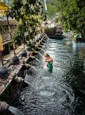 This image shows the sacred Tirta Empul Temple in Bali, known for its holy spring water that is believed to have purifying and healing properties. Visitors can bathe in the flowing waters from stone spouts, participating in a spiritual cleansing ritual that has been practiced for centuries. The lush, green surroundings and serene atmosphere add to the temple's spiritual significance, making it a must-visit spot for those wanting to experience Bali’s rich cultural and religious heritage.
