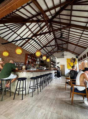 This image shows Ibu Susu Bar & Kitchen, an inviting cocktail bar and restaurant. Known for its creative cocktails like the Ubud Old Fashioned and a range of delicious food, this venue provides a cozy, welcoming atmosphere. It’s a great place to enjoy unique drinks and tasty bites while catching up with friends or unwinding after a day of sightseeing.