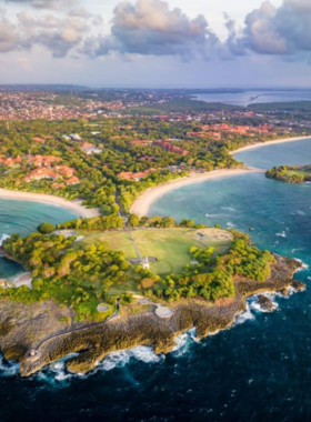 nusa-dua-beach-luxurious-relaxation This image shows Nusa Dua Beach in Bali, offering a calm and luxurious atmosphere. The image highlights the beautiful clear waters and soft sand, with several sunbeds set up for visitors to relax. The scene is serene, perfect for swimming, sunbathing, or enjoying water sports. The upscale resorts surrounding the beach contribute to the peaceful and premium vibe of the area.