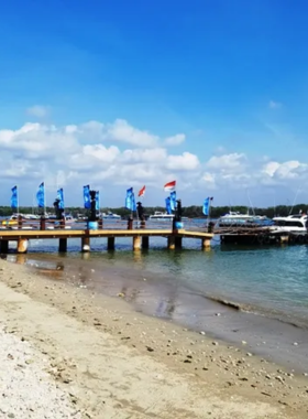 serangan-island-turtle-sanctuary This image shows Serangan Island in Bali, famous for its turtle sanctuary. The image captures the lush greenery of the island and the clear blue waters, with turtles swimming in the natural surroundings. Visitors can enjoy water activities such as snorkeling or kayaking while exploring the island’s beauty and contributing to conservation efforts for marine life.