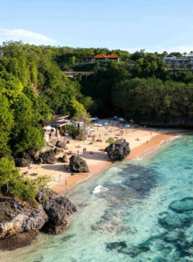 padang-padang-beach-secluded-relaxation This image shows Padang Padang Beach in Bali, a hidden gem surrounded by cliffs and lush greenery. The image captures the tranquil, clear waters perfect for a swim or surf. The secluded atmosphere offers a peaceful escape, ideal for relaxing, taking photos, or enjoying the surf. This beach is a serene spot for visitors seeking peace and natural beauty.