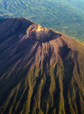 mount-agung-hiking-summit-view This image shows the breathtaking view from the summit of Mount Agung, Bali's highest peak. The image captures the expansive panoramic view from the top, offering a rewarding vista of the island after a challenging hike. Mount Agung’s volcano trek is a popular adventure for experienced hikers, providing both a physical challenge and a chance to witness Bali’s beauty from above.
