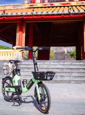 Cycling Through Hue This image shows a cyclist riding through the historic streets of Hue. The scenic route includes views of the Imperial City, the Perfume River, and lush surroundings, providing a leisurely way to explore the rich cultural heritage and picturesque landscape of Vietnam’s ancient capital.