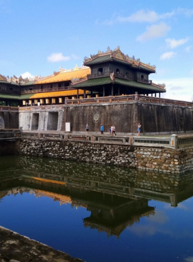 Hue Imperial City Architecture This image shows a visitor walking through the grand architecture of the Hue Imperial City. The ancient palaces, temples, and intricate details reflect Vietnam’s royal past, offering a glimpse into the country’s rich history and cultural significance, making it a must-see for history lovers.