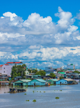 This image shows that the Mekong Delta, with its winding rivers and lush countryside, offers a unique boating experience. Visitors glide through floating markets and small canals, surrounded by stilt houses and vibrant villages, immersing themselves in the traditional, water-based way of life.