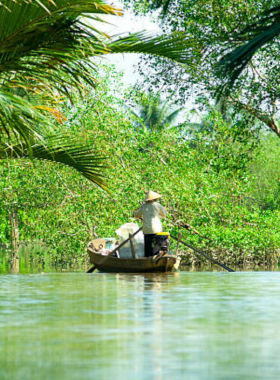 This image shows a bustling floating market in the Mekong Delta, with colorful boats loaded with fresh fruits, vegetables, and goods. The vibrant scene captures the region’s lively culture, offering a unique perspective of life along the waterways.