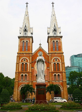 This image shows the Saigon Notre-Dame Cathedral, a majestic French colonial church located in the heart of Ho Chi Minh City. The cathedral’s two towering spires, intricate stained-glass windows, and impressive facade stand out against the city’s skyline. The cathedral is not only a place of worship but also a historical landmark that reflects the influence of French colonialism on the city’s architecture and culture, attracting visitors who admire its beauty and historical significance.