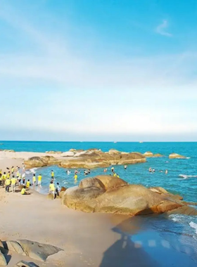 This image shows Long Hai Beach during a stunning sunset. The golden hues of the setting sun reflect on the calm ocean waters, creating a magical ambiance. A few visitors are seen walking along the soft sandy shore, while fishing boats are anchored nearby. The serene environment of the beach, combined with the picturesque sunset, offers a perfect escape for anyone looking to relax and rejuvenate.